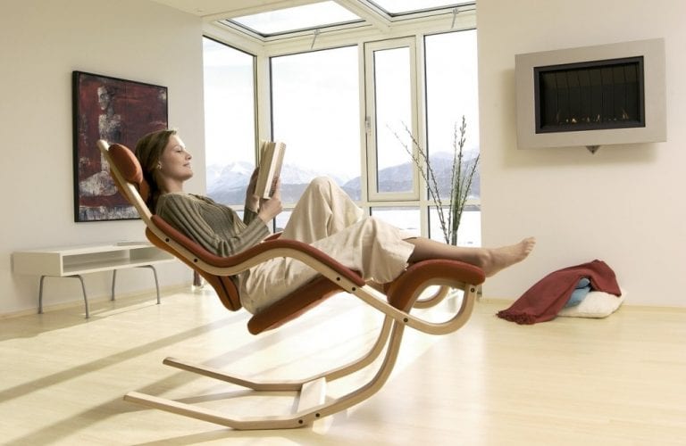 woman reading book in zero gravity chair